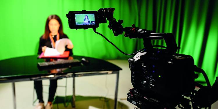 woman-sat-presenting-whilst-being-recorded-in-tv-studio