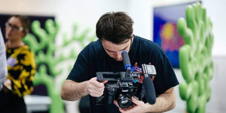 Student uses hand-held camera to film