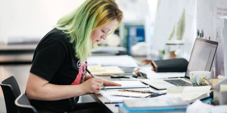 Student sits working at a desk