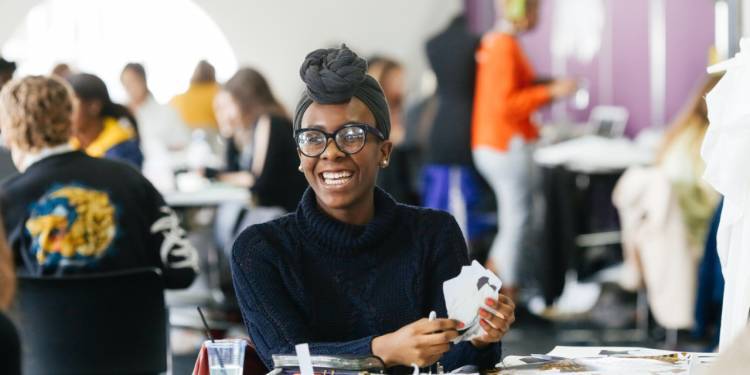 Student smiles while sitting in class