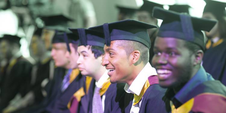 Four male graduates during the award ceremony