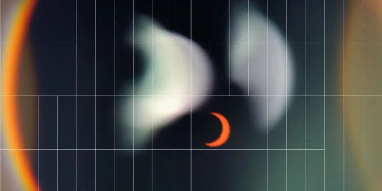 out of focus picture of an orange eclipse