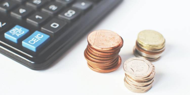 Change organised in piles next to a calculator