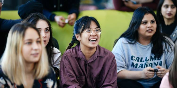 Group of female students playing computer games together