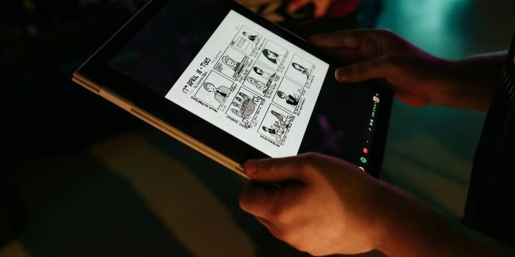 An iPad showing a digitally drawn black and white comic strip