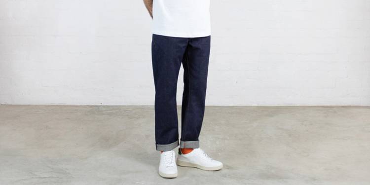 A man wears jeans from the Clown Hiut Denim collection