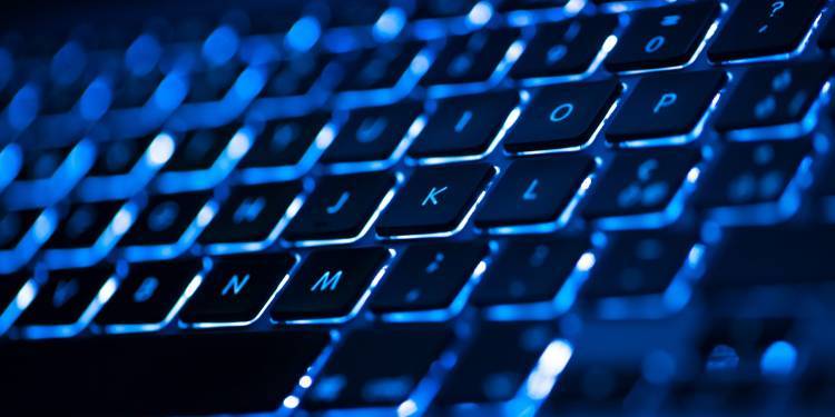 Zoomed in image of a keyboard in neon lighting