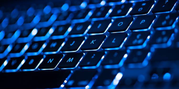 Zoomed in image of a keyboard in neon lighting