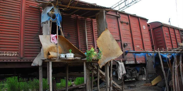 Photograph of makeshift dwellings in train carriages