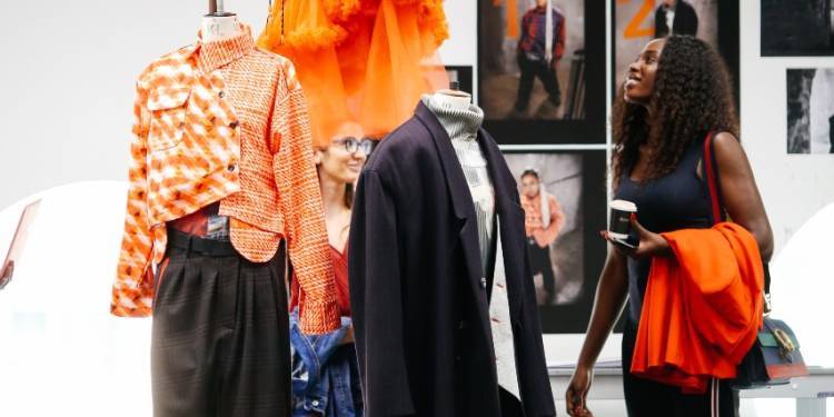 woman looks up at display of fashion coursework