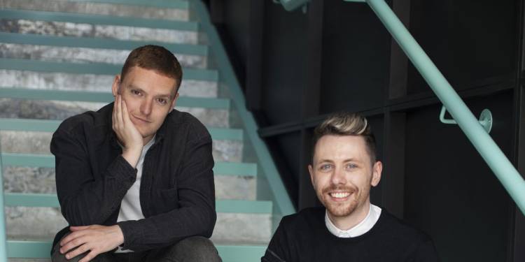 Jack Brown and Lee McMahon sit on stairs