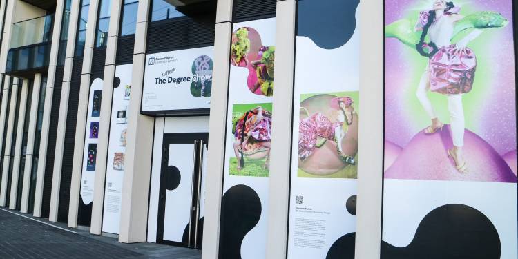 Students' work displayed on a building on Greenwich Peninsula