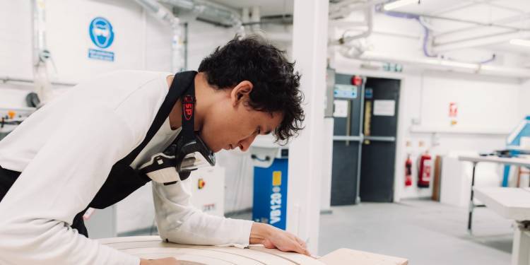 Calum Gambrill working on a rounded wood structure