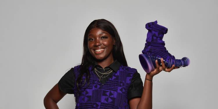 Edwina Arthur poses with her award-winning footwear