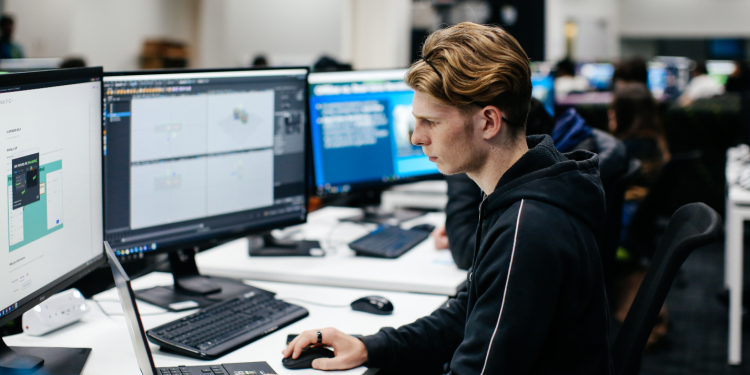 Man looking at computer screens