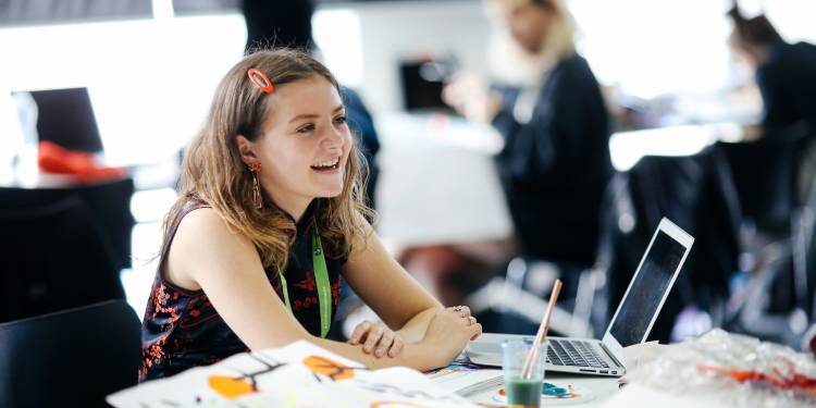Young woman smiling at her laptop
