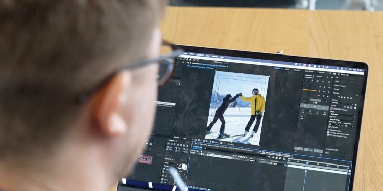 Man wearing glasses works on his laptop