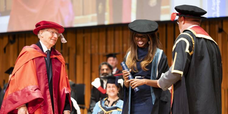 June Sarpong collects scroll on stage