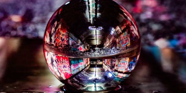 Glass globe reflecting a street view at night