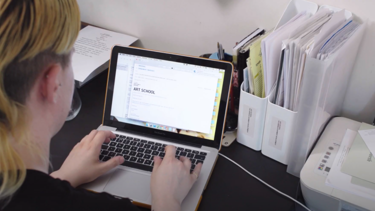 Image of Eden Loweth sat at a laptop