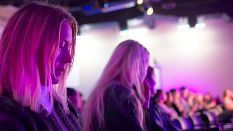 Girl sat in the crowd at an In Conversation event