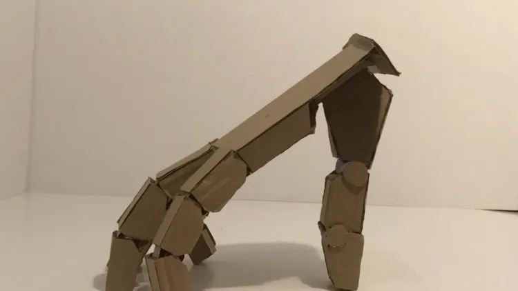 3D hand made of brown cardboard in a white box ready to dance