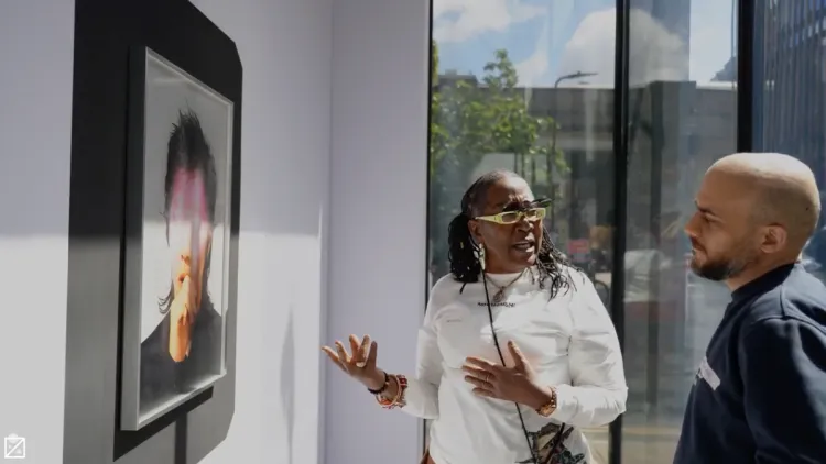 Two people looking at a photo in an exhibiton
