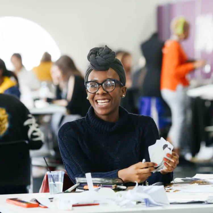 Student smiles while sitting in class