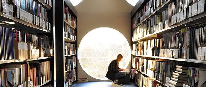 Students looking through books in the library