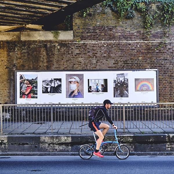 A billboard depicting images from the Hold Still competition