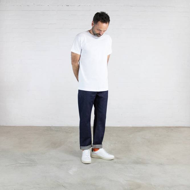 A man wears jeans from the Clown Hiut Denim collection