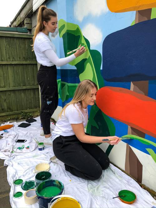 Image of Kirsty and Brittany from K&B Design painting a mural