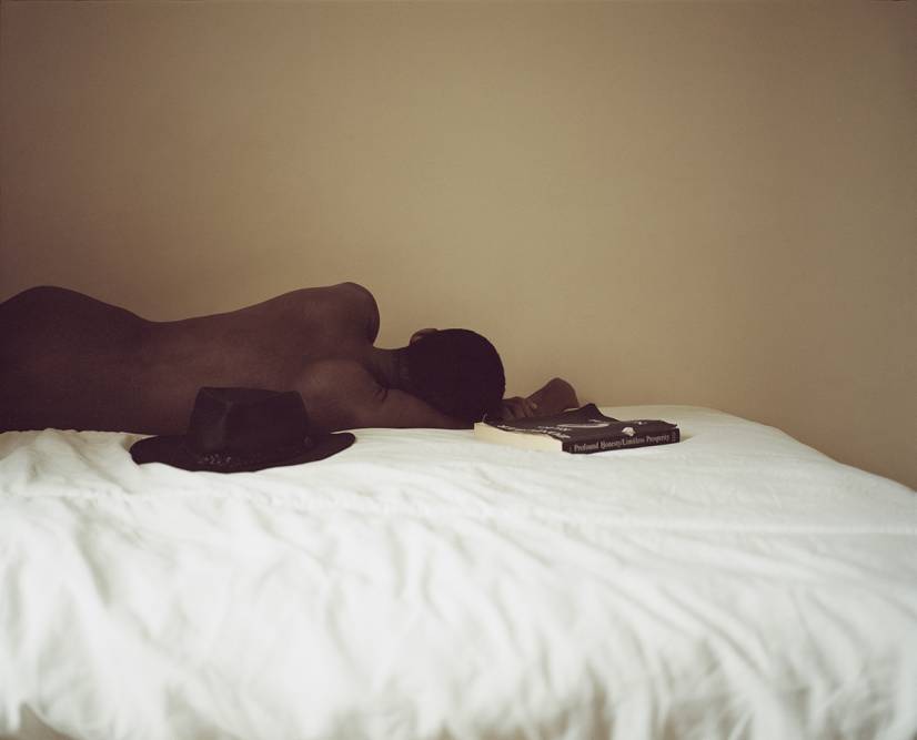 A contemplative picture of a man lying on his father's bed