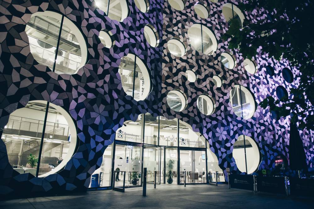 The Ravensbourne building lit up for a cosy evening