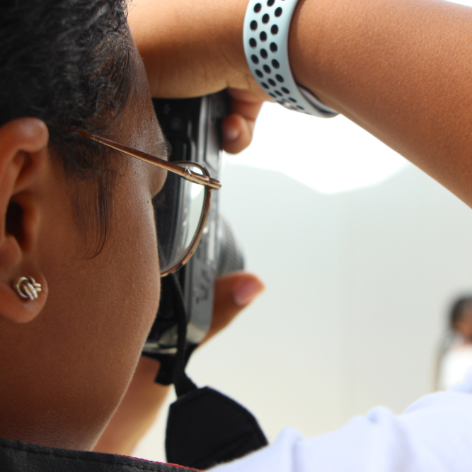 a close up image of a young woman holding a camera