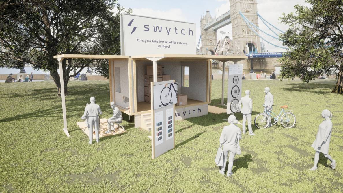 A simple, sleek wooden stand in a London park with bike wheels hanging on the walls