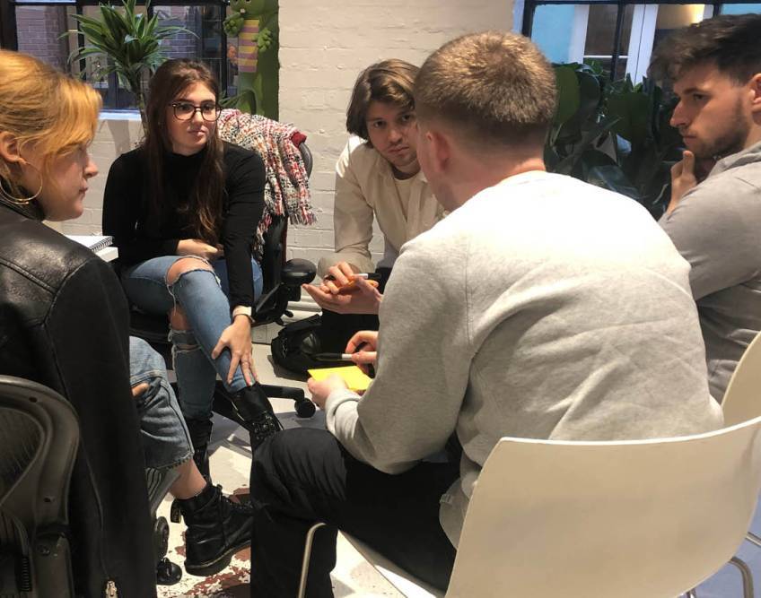 Students huddled round a table