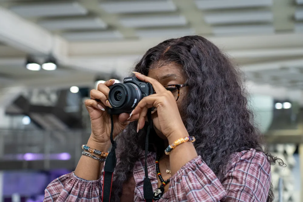 Student using a Canon EOS DSLR camera from Ravensbourne's kit store