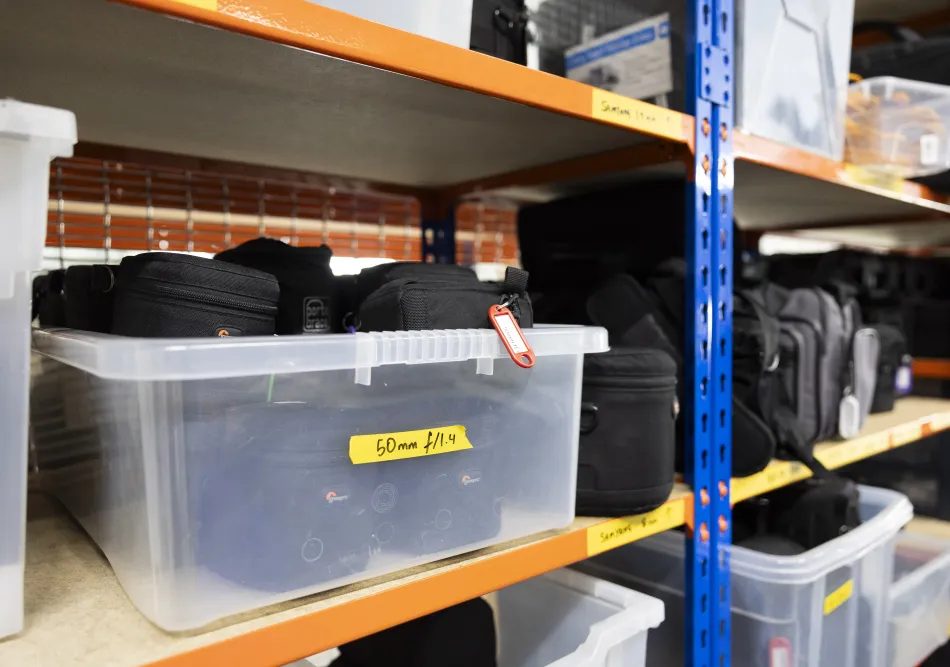 Box of 50mm camera lenses in storage in Ravensbourne's kit store