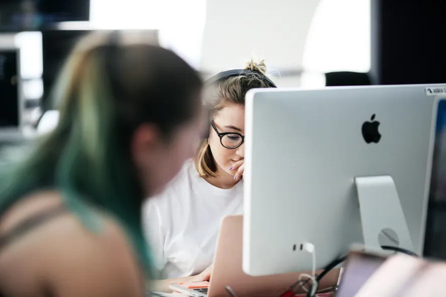 woman sat working at imac suite