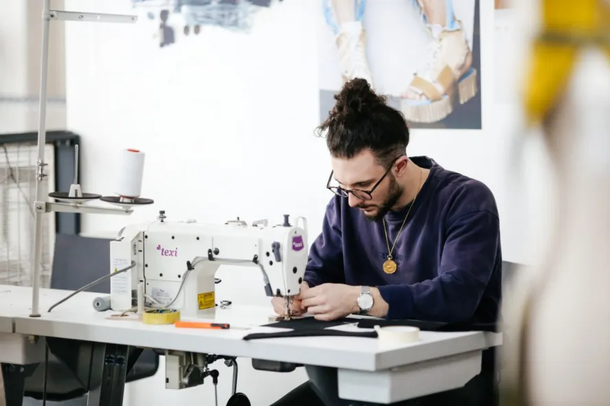 Male student working on a fashion atelier