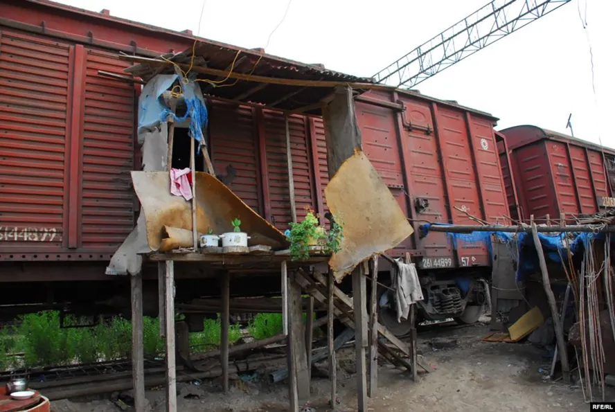 Photograph of makeshift dwellings in train carriages