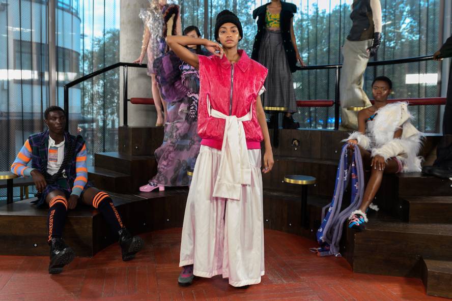 Models pose in front of wooden steps