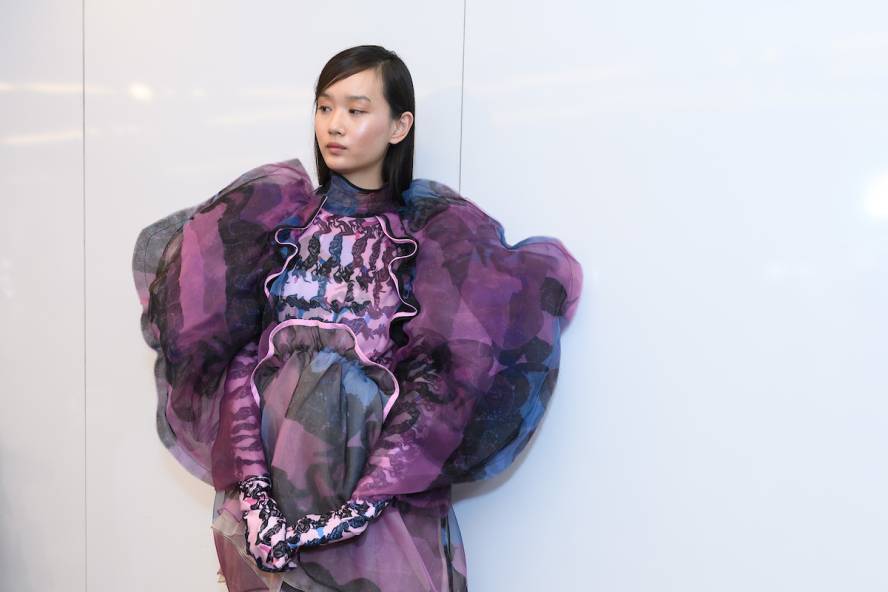 Model wearing purple outfit