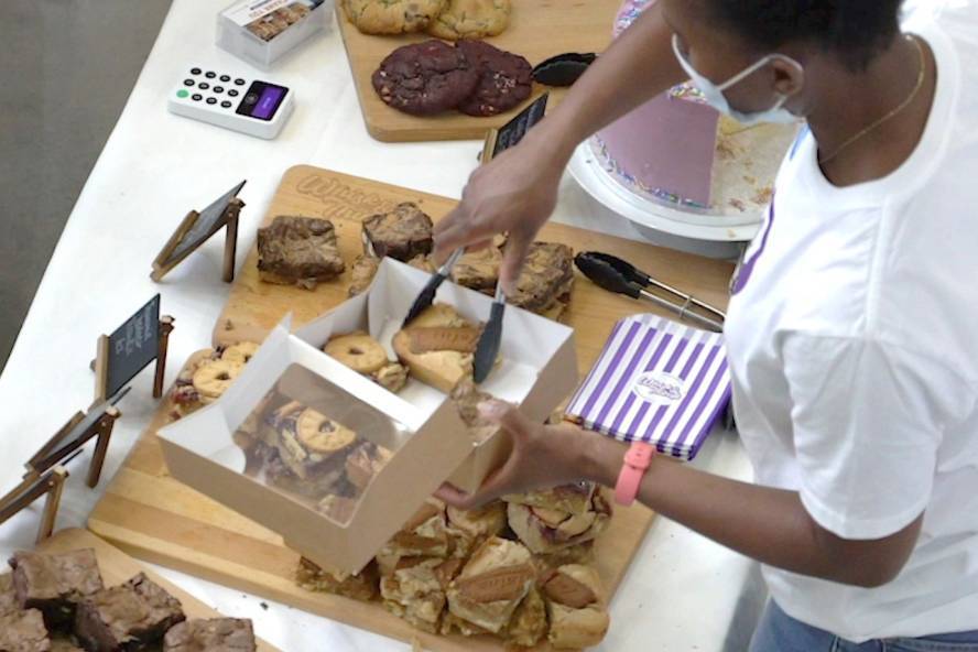A business vendor serves brownies