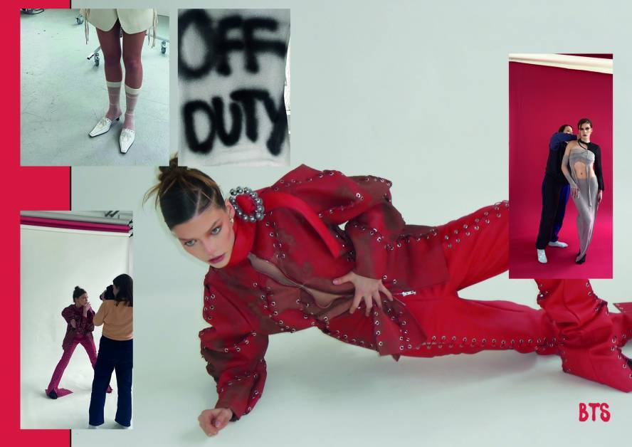 Model in all red boiler suit poses kneeling on forearm 