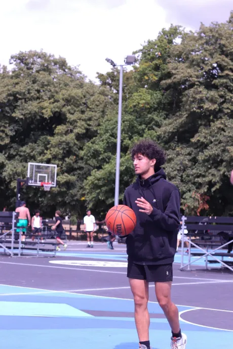 Male basketball player holds ball on the pitch