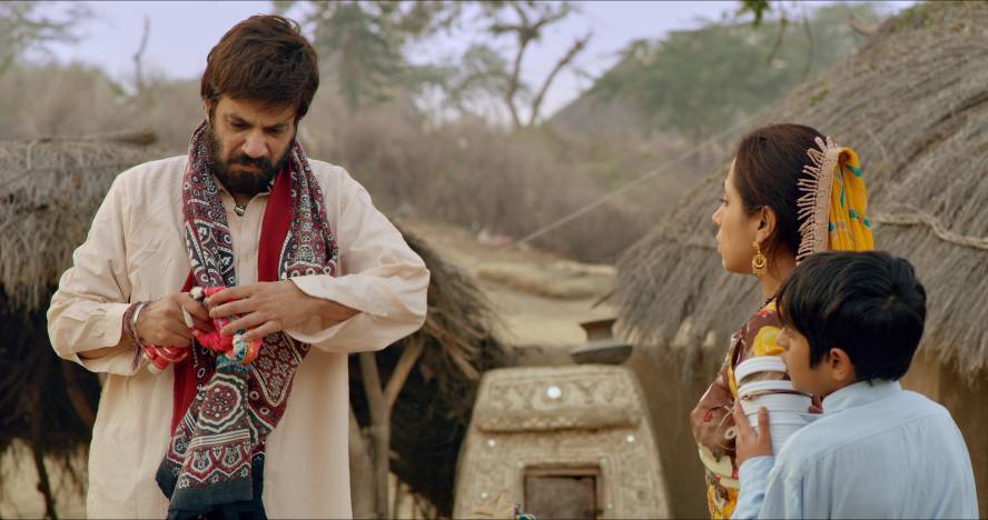 A father breaks a toy doll as a young male-presenting child looks on