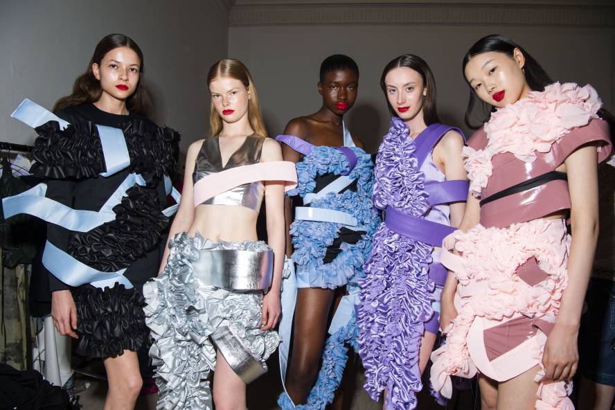 Models wear delicate outfits with ruffles and banding
