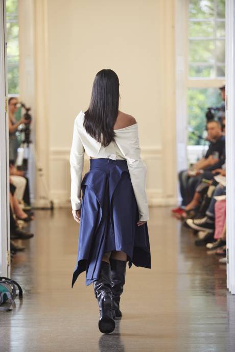A model walks away from the camera in elegant ruffled skirt